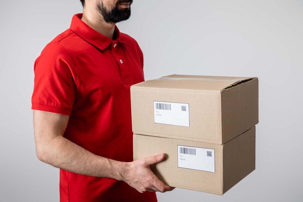 cropped-view-of-delivery-man-in-uniform-carrying-c-KQQGMWG.jpg