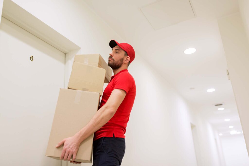 mage suggestion: Team of movers carefully loading furniture into truck outside Olaya high-rise